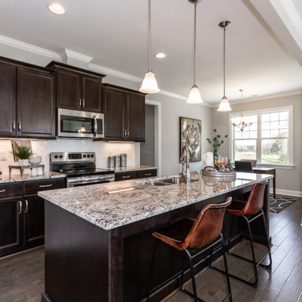 Winslow Custom Homes Kitchen with black cabinets and pendant lights