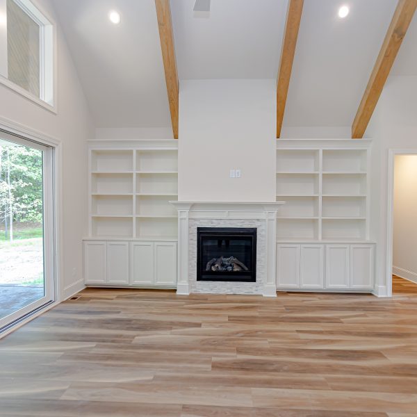 Winslow Custom Homes Living room with fireplace and bookshelves