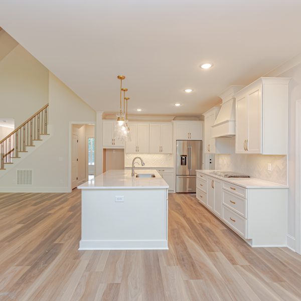 Winslow Custom Homes Kitchen with light floors and white cabinets